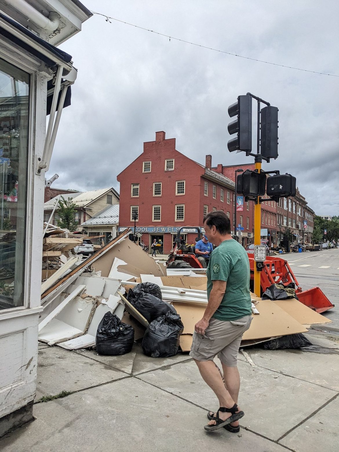 workers cleaning up a flooded street